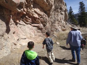 examining a rock face while on a rock collecting trip