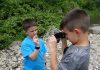 kids rock collecting in a rocky area