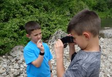 kids rock collecting in a rocky area