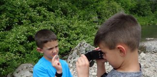 kids rock collecting in a rocky area