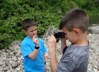 kids rock collecting in a rocky area