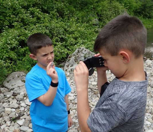 kids rock collecting in a rocky area