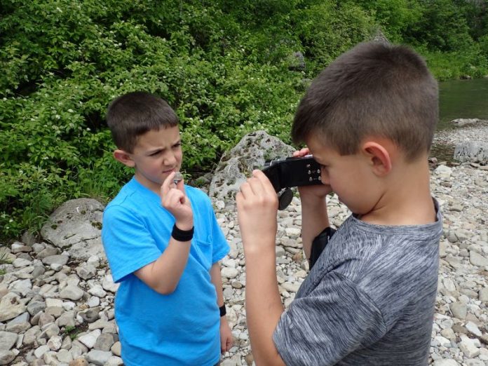 kids rock collecting in a rocky area