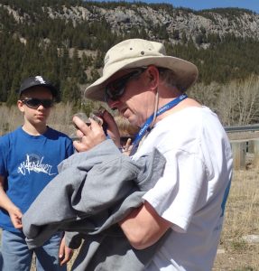 examining a rock while rock collecting