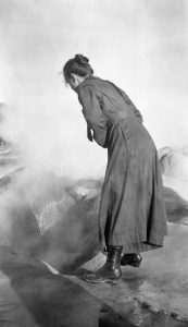 Yellowstone visitors examining a thermal feature