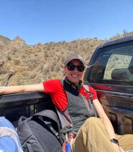 allison reann kusick in the back of a pickup truck as she is studying and learning about careers in geology