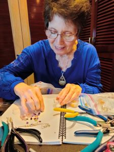 julie park making a wire wrapped pendant as lapidary is her careers in geology choice