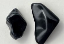 a piece of jet stone and a piece of obsidian for comparison