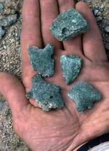 trinitite specimens in a an open palm