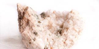 pink danburite rough on white background