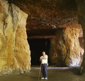 man standing next to columns in the widow jane mine